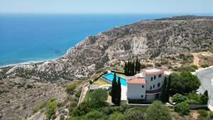 a house on a hill next to the ocean at Matteo Villa Limassol Cyprus in Limassol