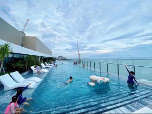 a pool on a cruise ship with people in the water at The Sóng Vũng Tàu Homestay - Suri's Apartment in Vung Tau