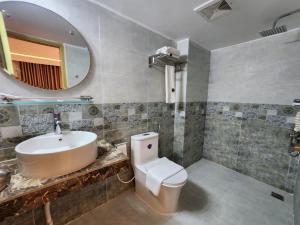 a bathroom with a sink and a toilet and a mirror at Sea Paradise in Cox's Bazar +73 photos
