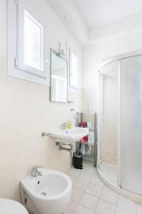 a bathroom with a sink and a toilet and a shower at 200m from the sea, beach place included in Lido di Jesolo +11 photos