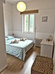 a bedroom with two beds and a window at Gîte dans Bastide Provençale, Piscine & Sauna in Auriol
