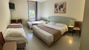 Postel nebo postele na pokoji v ubytování Abel Hôtel