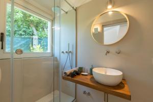 a bathroom with a sink and a glass shower at Villa Morea & Rooms in Procida in Procida