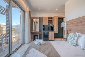 a bedroom with a bed and a large window at Xasteria in Elafonisi
