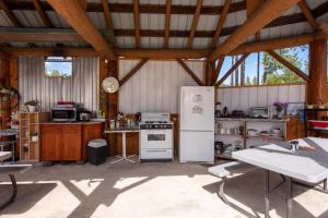 a kitchen with a stove and refrigerator in a barn at Blue River Cabins & Campgrounds in Blue River