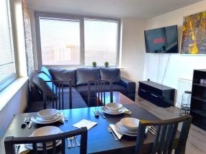 a living room with a table and a couch at Central Retreat- A Cosy 2 Bedroom Flat with View in L3 in Liverpool