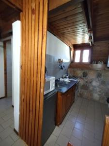 a kitchen with a sink and a microwave at La cumbrecita village in La Cumbrecita