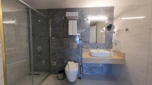 a bathroom with a sink and a glass shower at Mai İnci Otel in Antalya
