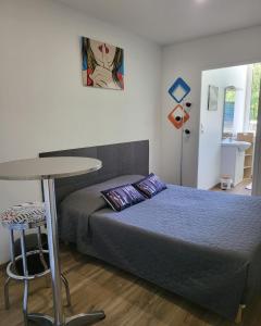 a small bedroom with a bed and a table at alpes hotel barreme in Barrême