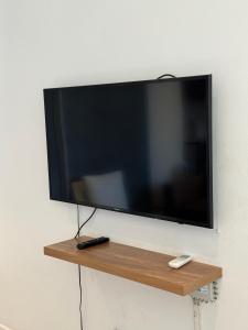 a flat screen tv hanging on a wall at Cosy one bedroom apartment in Windhoek