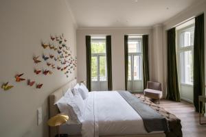 a bedroom with a bed with butterflies on the wall at Nine Athens Hotel in Athens