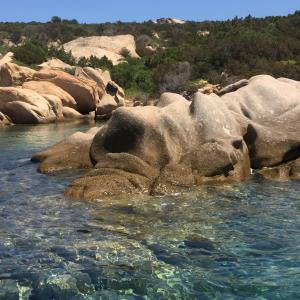 a group of rocks in a body of water at HOTEL Al FARO , SPIAGGIA LA CINTA ,SAN TEODORO in San Teodoro