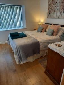 a bedroom with two beds and a window at Rose's Cottage in Gorran Haven