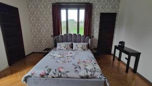 a bedroom with a large bed with a blue headboard at Villa Giordana in Casalborgone