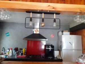 a kitchen with a counter top with a stove top oven at le lys dans la vallée d ustou in Ustou