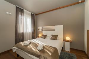 a bedroom with a large bed with two pillows at Luxury Rooms and Apartment Silente Bacvice in Split