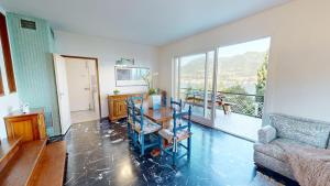 a living room with a table and chairs and a balcony at Villa Elvira in San Felice del Benaco +37 photos