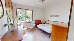 a room with two beds and a table and chairs at Villa Elvira in San Felice del Benaco