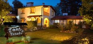 a large house with a sign in front of it at Posada Tantra in Villa General Belgrano