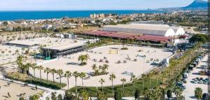 an aerial view of a park with palm trees and a building at Casa Laya en Oliva Nova in Oliva