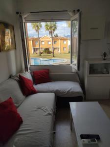 a living room with two couches and a window at Casa Laya en Oliva Nova in Oliva
