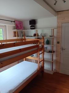 a room with two bunk beds and a door at Superbe gite au centre de Kaysersberg avec 3 chambres in Kaysersberg