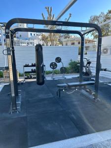 a gym with a punching bag in a parking lot at Relux Ios Hotel in Ios Chora