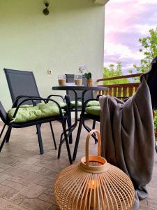 a patio with a table and chairs on a balcony at Apartman Lana in Jajce