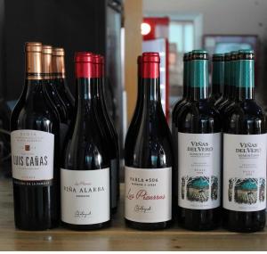 a group of four bottles of wine sitting on a shelf at Hostal el secreto in Teruel