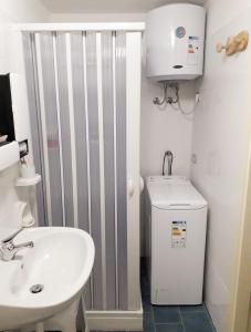 a bathroom with a toilet and a sink at Casa Ernesto in Pisticci +38 photos