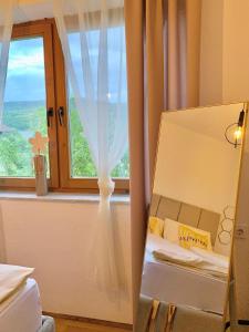 a room with a window and a white curtain at Apartman Lana in Jajce