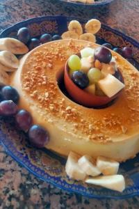 a cake with fruit on top of it on a plate at LA GRANJA in Tetouan