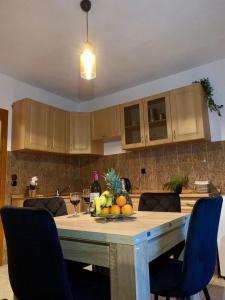 a kitchen with a table with a bowl of fruit on it at Apartman Lana in Jajce +24 photos