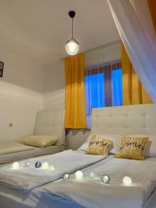 a bedroom with two beds and a window at Apartman Lana in Jajce