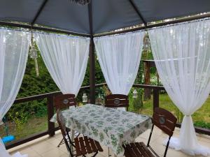 a table and chairs in a room with a window at Domek w Borach Tucholskich - Wycinki in Wycinki