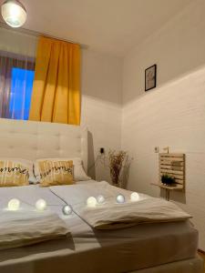 a bedroom with a large bed with lights on it at Apartman Lana in Jajce