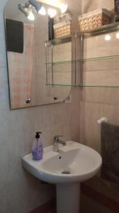 a bathroom with a white sink and a mirror at Casa Lomas in Arcos de la Frontera
