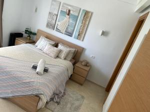 a bedroom with a bed with two pictures on the wall at Appartement haut standing CFC Casablanca in Casablanca