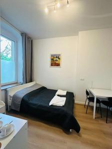 a bedroom with a bed and a table and a tableablish at Nice apartment in Berlin3 in Berlin