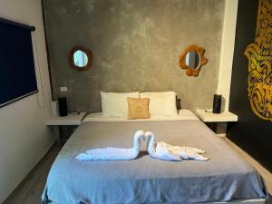 a bedroom with a bed with a towel on it at Saboga Lodge in Saboga