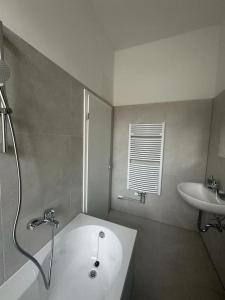 a bathroom with a sink and a bath tub and a sink at Nice apartment in Berlin3 in Berlin +1 photo
