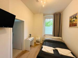 a small bedroom with a bed and a window at Nice apartment in Berlin3 in Berlin