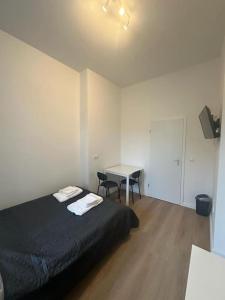a bedroom with a bed and a table in it at Nice apartment in Berlin3 in Berlin +1 photo