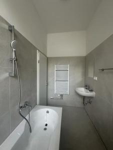 a bathroom with a bath tub and a sink at Nice apartment in Berlin3 in Berlin