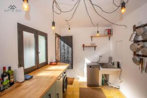 a kitchen with a wooden counter and a sink at Casa de los hermanos in Almuñécar