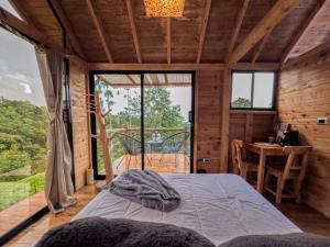 a bedroom with a bed in a room with a table at Rùstico Glamping in Santa Elena