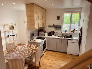 a kitchen with a table and a dining room at Secalonia - duplex cosy in Salbris