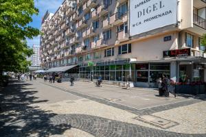 a street in front of a building with people walking on the sidewalk at Warsaw Centrum Apartment - Workspace, Balcony - by Rentujemy in Warsaw