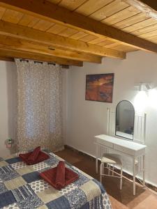 a bedroom with a bed with a mirror and a desk at Hamre Apartments (Nicholas) in Agios Georgios Pagon