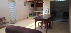 een keuken met een houten tafel in een kamer bij Casa de Hospedagem Uberaba in Uberaba